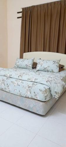 Ένα ή περισσότερα κρεβάτια σε δωμάτιο στο TheBungaTulipsHomestay