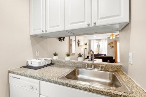 a kitchen with a sink and white cabinets at Modern And Cozy 2br Apt in Philadelphia