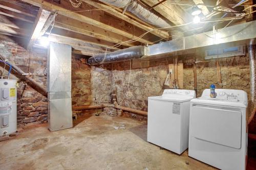 a laundry room with two washer and dryers in it at A Spacious Lovely 2 Bedroom Flat With Private Yard in Philadelphia