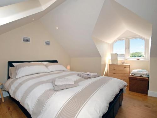 a bedroom with a large bed and a window at Charnwood Cottage in Dale