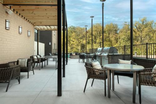a patio with tables and chairs on a building at TownePlace Suites by Marriott Cincinnati Mason in Mason