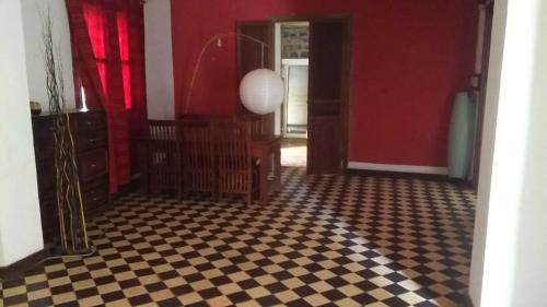 a room with red walls and a checkered floor at Satrana beach in Ambaro