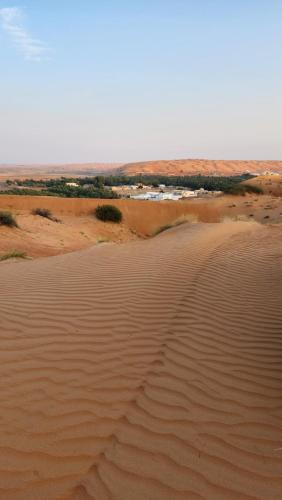 an aerial view of a desert with sand dunes at Bidiyah Domes in Badīyah