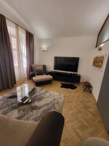 a living room with a couch and a television at MONAR Exclusive apartment in old town Košice in Košice