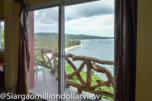 a window with a view of the ocean at Siargao Million Dollar View in Burgos