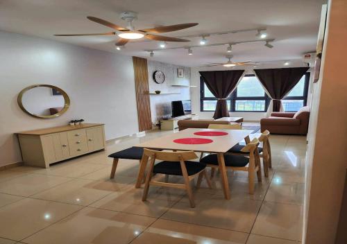 a kitchen and living room with a table and chairs at 5 mins to IKEA Mytown M Vertica Hanan Residence in Kuala Lumpur