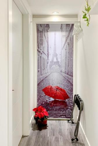 a red umbrella in a street with the eiffel tower at Private Studio Suite with Full Bath - Parking - 15 mins to Downtown in Vancouver