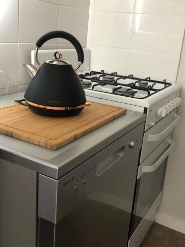 a black tea kettle sitting on top of a stove at Daisy House - Whittington - 10 minutes to central Geelong in Whittington
