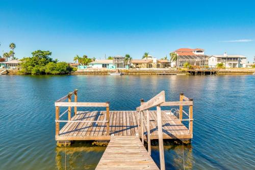 a wooden dock in the middle of a body of water at Waterfront Florida Escape with Deck and Private Dock! in Hernando Beach