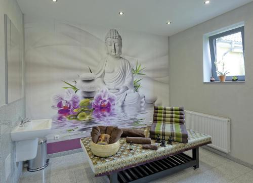 a room with a buddha mural on the wall at Nella Parkhotel in Steinhude