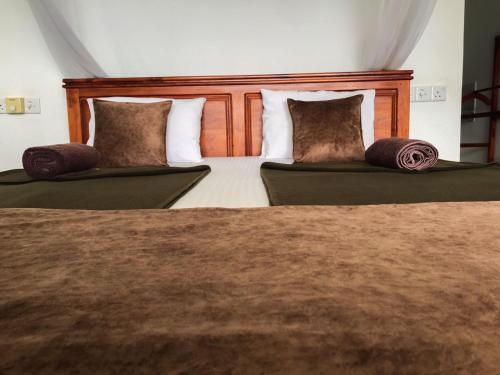 two beds with pillows on them in a bedroom at Two Rock Vista in Ella