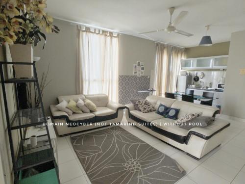 a living room with two couches and a kitchen at Tamarind Suites or D'Pulze Residence or Domain NeoCyber, click Room selection for location and pics in Cyberjaya