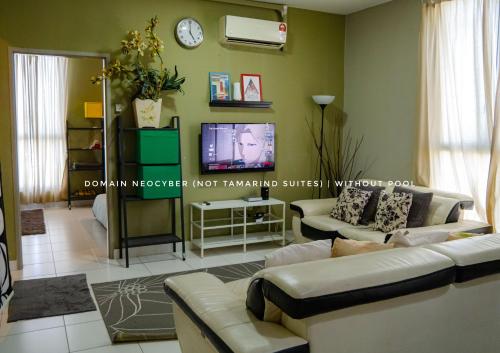 a living room with a couch and a tv at Tamarind Suites or D'Pulze Residence or Domain NeoCyber, click Room selection for location and pics in Cyberjaya