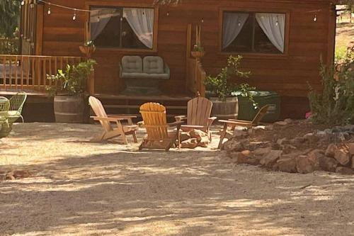 a patio with chairs and a table in front of a house at B-B Ranch Cottage~Heart of Gold Country~*HOT TUB* in Pilot Hill
