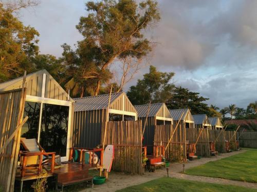 a row of wooden cabins in a row at Walden Koh Lanta - Tiny Homes by the Sea in Ko Lanta