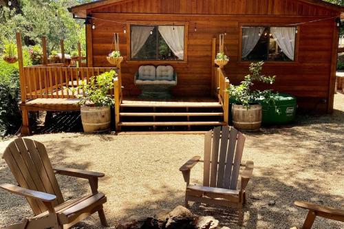 a couple of chairs sitting in front of a cabin at B-B Ranch Cottage~Heart of Gold Country~*HOT TUB* in Pilot Hill