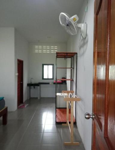 a room with a room with a table and a fan at Som PalmGarden in Ko Lanta