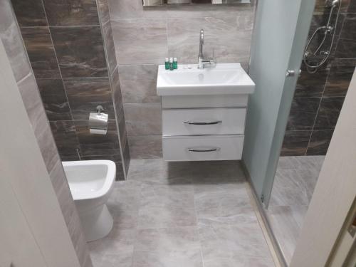 a bathroom with a sink and a toilet at Panorama-Madinah-ZamZam -Halal Hotels Group in Baku