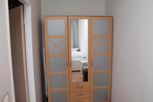 una porta alta in legno con specchio in una stanza di Ferienwohnung L113 für 2-4 Personen an der Ostsee a Brasilien (Schönberg)