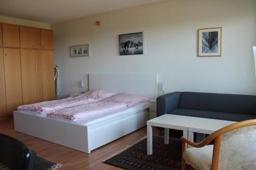 ブラズィリアンにあるFerienappartement K1318 für 2-3 Personen mit Ostseeblickのベッドルーム1室(ベッド1台、ソファ、テーブル付)