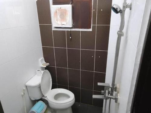 uma pequena casa de banho com um WC e uma janela em City Backpackers em Luang Prabang
