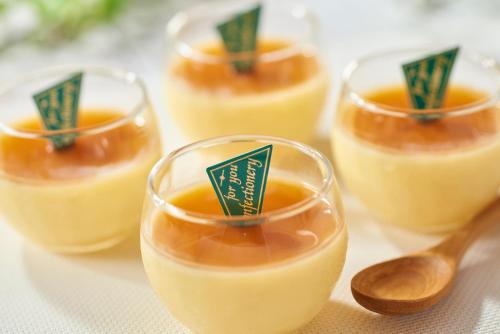 a group of small glasses of food with a wooden spoon at Hiroshima Tokyu REI Hotel in Hiroshima