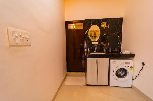 a laundry room with a washing machine and a sink at The Roma Homestay in Sarnath Varanasi in Varanasi