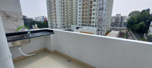 a balcony with a sink and a view of a city at Tranquil Serviced Apartments - Sarjapur in Bengaluru