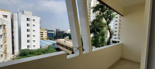 an empty balcony with a view of a city at Tranquil Serviced Apartments - Sarjapur in Bengaluru