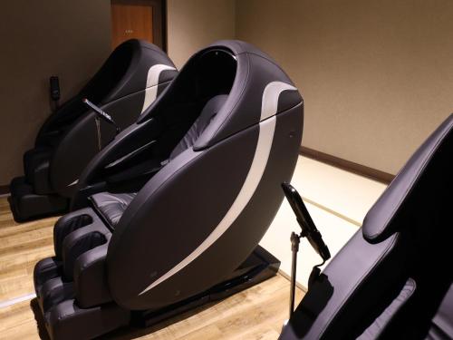 a row of chairs sitting in a room at Beppu Hatto Onyado Nono Beppu in Beppu