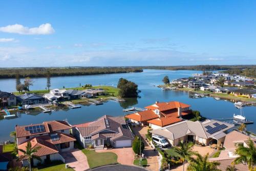arial view of a village on the water with houses at The Ballina House in East Ballina