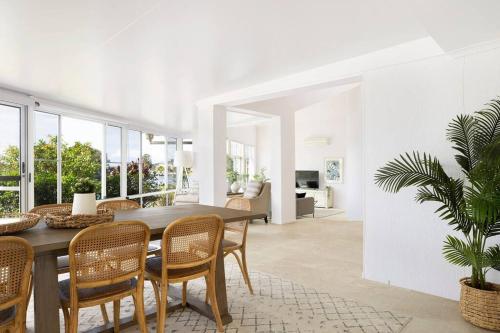 a dining room with a table and chairs at The Ballina House in East Ballina