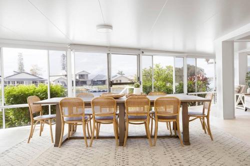 a dining room with a table and chairs at The Ballina House in East Ballina
