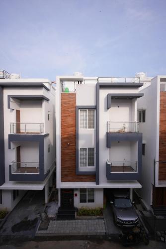 two white buildings with balconies on them at Aayushman Luxury Homes in Sarjāpur