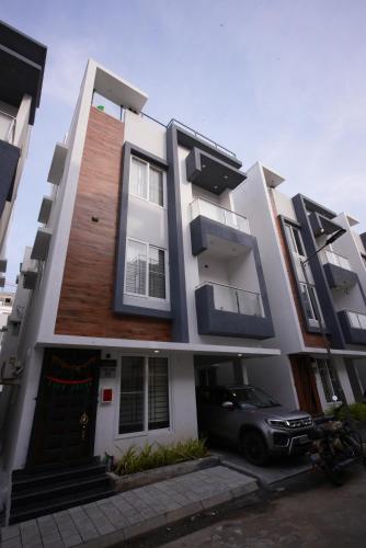 a building with a car parked in front of it at Aayushman Luxury Homes in Sarjāpur