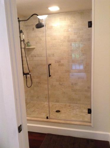 a shower with a glass door in a bathroom at Haddock Hill House in Old Chatham