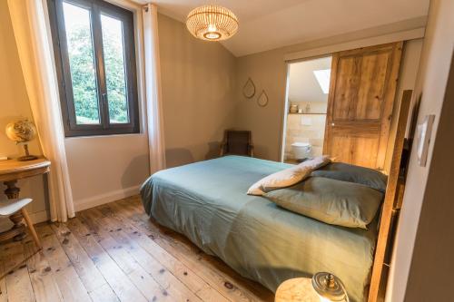 a bedroom with a bed and a window at La maison d'à côté in Mont-de-Marsan