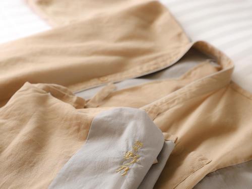 a close up of a tan saree with gold embroidery at Beppu Hatto Onyado Nono Beppu in Beppu