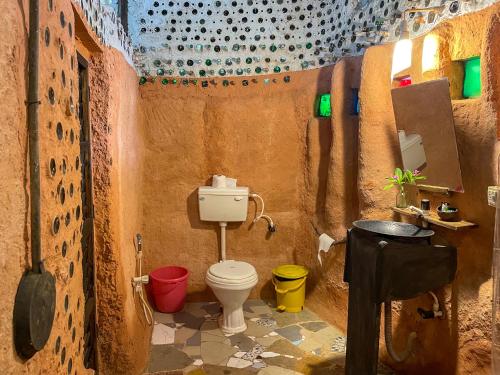 a small bathroom with a toilet and a sink at Saraya in Sangolda