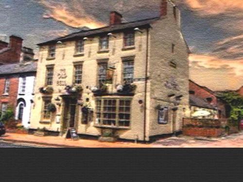 a large white building on the side of a street at The Old Bell in Shrewsbury