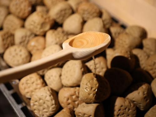 a wooden spoon in a pile of different types of cookies at Beppu Hatto Onyado Nono Beppu in Beppu