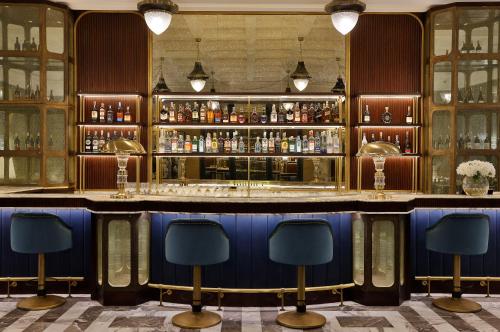 a bar with a blue counter and some chairs at Waldorf Astoria Cairo Heliopolis in Cairo