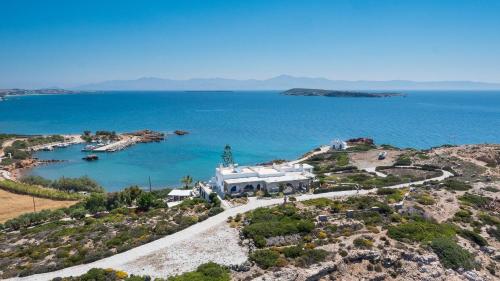 an aerial view of a house on a hill next to the ocean at Martineli Residence - A Beachfront Estate in Drios