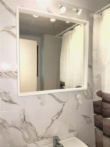 a bathroom with a mirror and a sink at Castle H 408 in Los Cristianos