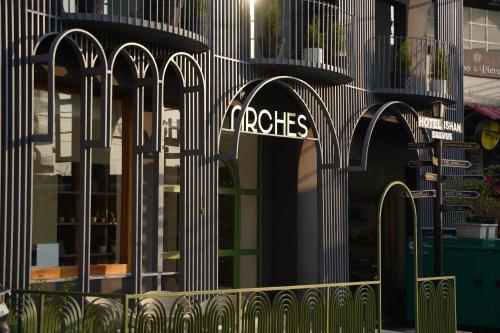 a store with arches on the side of a building at Hotel Ishan - A Riverside Retreat by Salvus in Rishīkesh