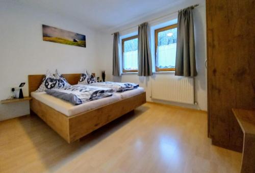 a bedroom with a bed and two windows at Bichlerhof in Radfeld