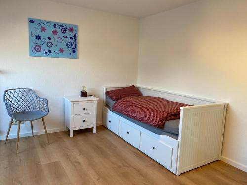 a small bedroom with a bed and a chair at Ferienwohnung Blumenau in Bad Berneck im Fichtelgebirge