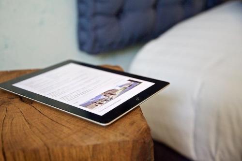 a tablet sitting on top of a wooden table at La Grange de Boulaines in Méru