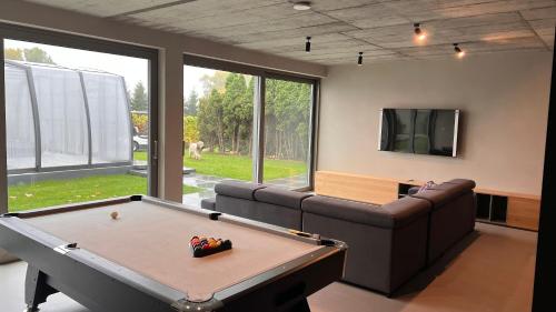 a living room with a pool table and a couch at LedowoHouse Industrial Style kids friendly in Lędowo