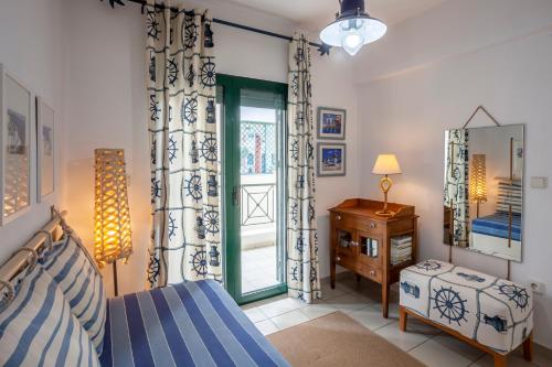 a bedroom with a bed and a dresser and a window at Seaside Bungalow in Pefkochori